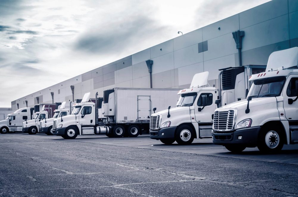 Delivering or Supply concept image.  Trucks loading at facility.