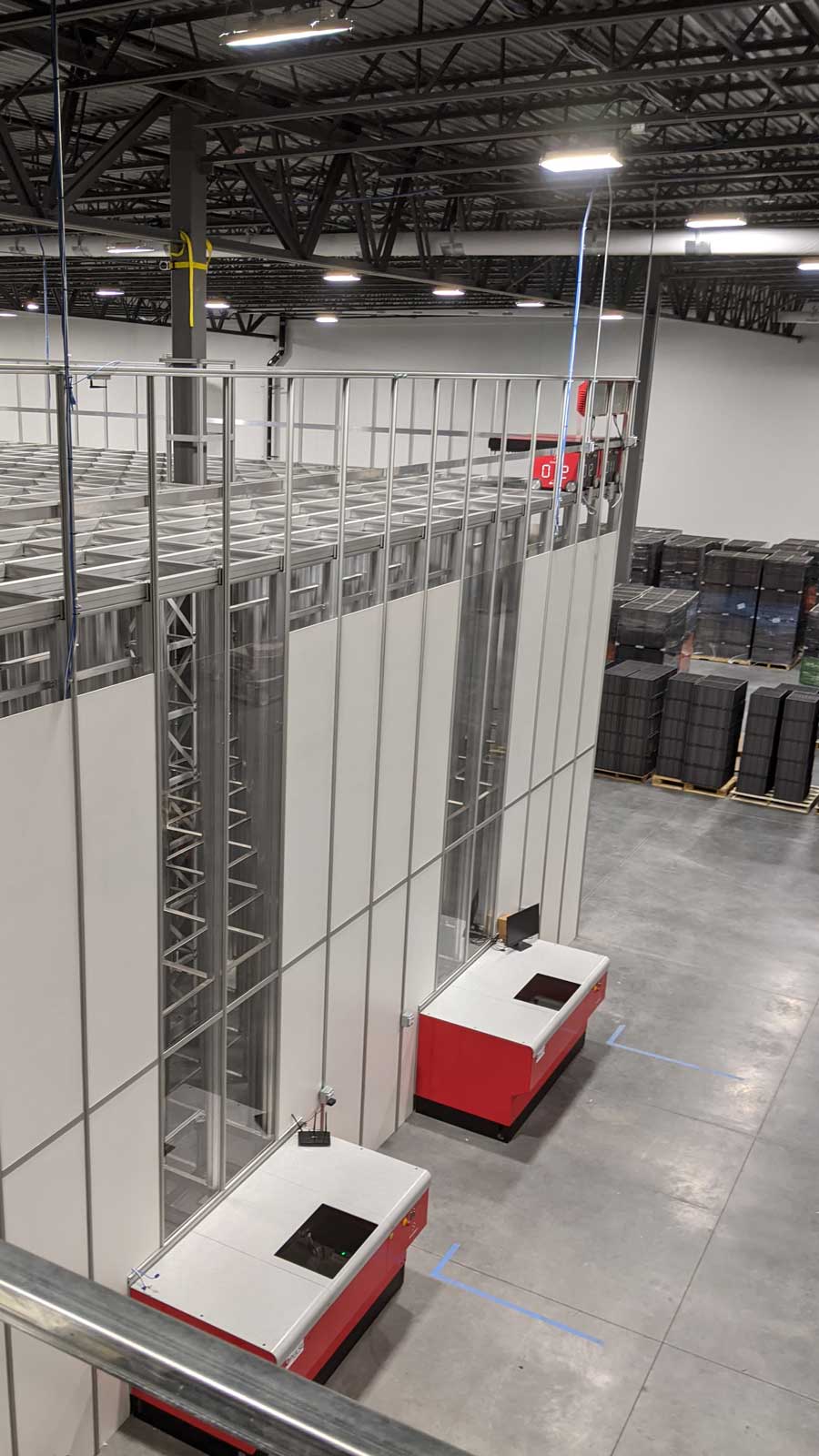 AutoStore grid and workstations in a retail distribution center