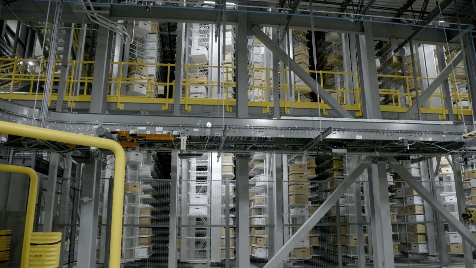 View of automated storage and retrieval system and conveyor in a meat distribution center.