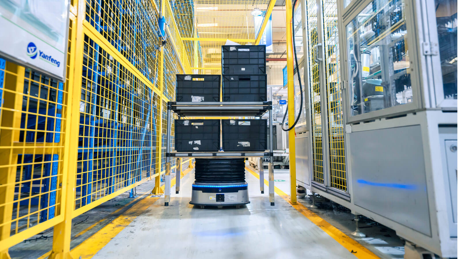 AMR Transporting Several Containers in Fenced Warehouse