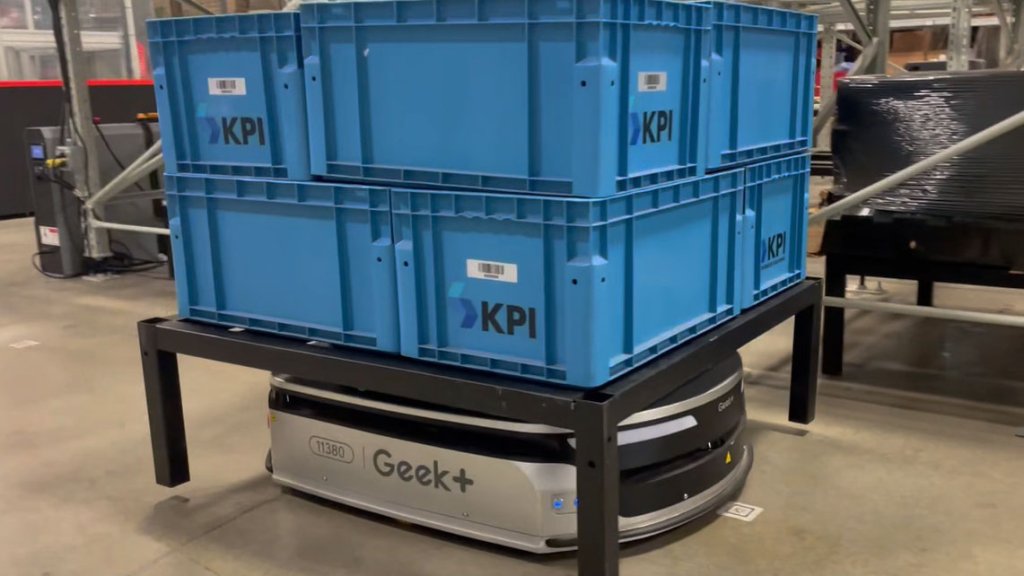 Geek+ AMR carrying totes in warehouse