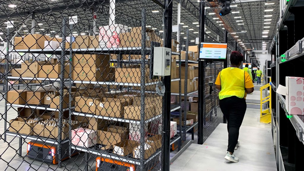 Worker Interacting with AMRs in Fenced Area