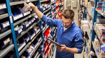 Maintenance worker locating spare warehouse parts